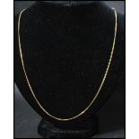 An 18ct gold chain necklace with spring hoop clasp. Marked 750, tests 18ct gold. Measures 22 inches.