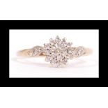 A hallmarked 9ct gold and diamond cluster ring set with a central cluster a single accent diamond