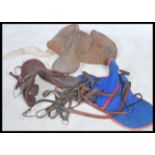 A collection of vintage 20th century horse racing equestrian items to include Jockey Silks , saddles