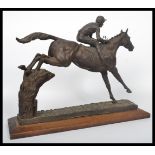 A good quality 20th century large bronzed resin sculpture of a steeplechase horse and jockey at a