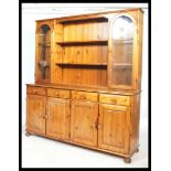 A good quality 20th century Pine welsh dresser by Ducal. The  base with a series of short drawers