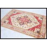 A large North Western Iranian / Persian Heriz carpet - rug having red and beige ground with