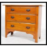 An early 20th century Edwardian walnut straight three cottage chest of drawers, drop handles