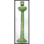 A 19th century Majolica candlestick in the manner of Minton's raised on a stepped circular base with