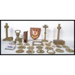 A collection of 19th and 20th century brass wares to include two pairs of candle sticks, horse