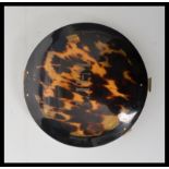 A 19th century Victorian tortoiseshell ladies compact of circular form. The tortoise shell lid