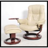 A retro Stressless reclining armchair and matching ottoman by Ekornes. Upholstered in cream