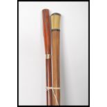A pair of early 20th century Edwardian walking stick canes one having a tapering bamboo shaft with