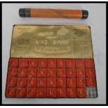 A vintage tin plate advertising pencil case calculator along with a Franklyn's fine shagg novel