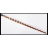 A vintage early 20th century walking stick cane having a hidden twist of section revealing a