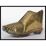 A 19th century ornamental hobnail boot / clog constructed from brass, wooden sole with hobnail