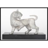 A 20th century silver plated Chinese figurine of a tiger raised on a plinth base. Measures 15 cm