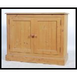 A good quality 20th century country pine school cupboard having double doors with shelved