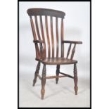 A good Victorian 19th century beech and elm wood windsor chair - armchair being raised on bulbous