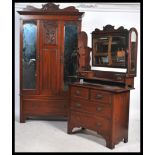 An Edwardian mahogany Art Nouveau wardrobe and dressing table bedroom suite. The wardrobe with