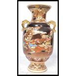 A 19th century Japanese Kutani vase having twin elephant handles. The body depicting fighting
