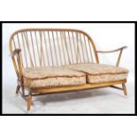 Ercol - A golden dawn Windsor two seater sofa / settee in beech and elm, having the propeller arm
