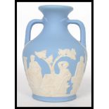 An early 20th century Edwardian Wedgwood small Portland vase, blue and white Jasper Ware with