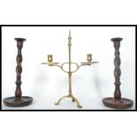 A group of three 19th century candlesticks to include a brass example raised on a tripod base with