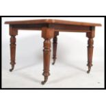 A late 19th / early 20th century mahogany windout dining table, with an additional leaf and winder