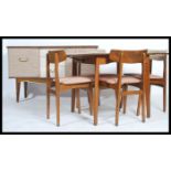 A retro mid century dining room suite comprising a sideboard, dining table and chairs. The