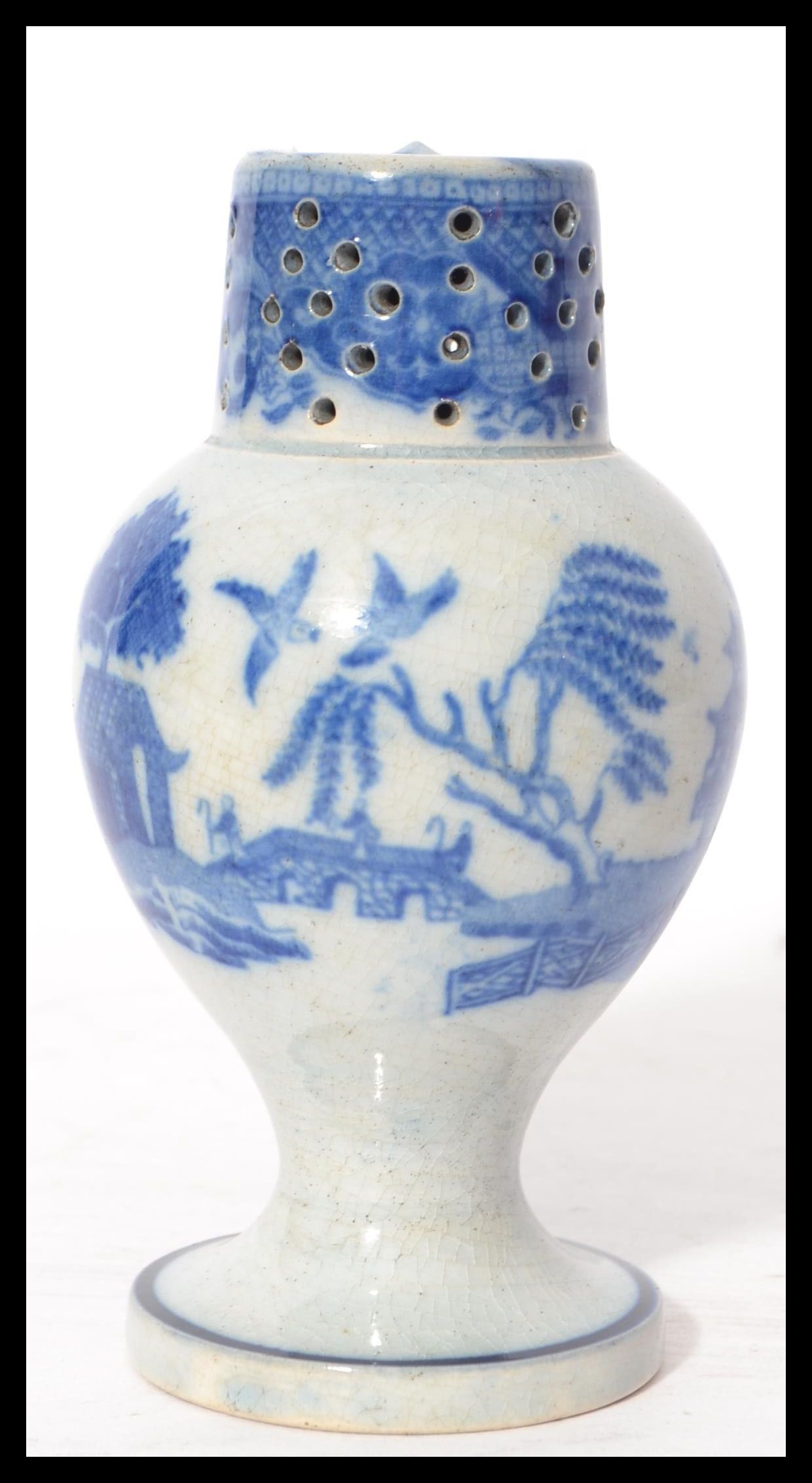 A 19th century blue and white ceramic sander pounce pot having a circular vase with bulbous body and