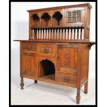 A 19th century Arts & Crafts oak sideboard dresser in the manner of Liberty & Co, London. The base