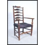 A 19th Georgian elm wood North Country carved armchair. The wavey ladder back armchair raised on