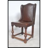 A 19th century Victorian leather wing back chair having a studded back with horse hair stuffed