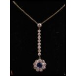 A vintage 18ct gold white gold, diamond and blue sapphire pendant necklace. The pendant consisting