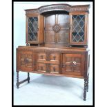 A 1920's oak barley twist dresser sideboard. The upright back with leaded glazed door cabinet over a