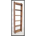 A 1930's Art Deco oak upright open window bookcase having panelled sides with gallery top and set of