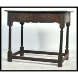 A late 18th / 19th century country oak Georgian lowboy side table being raised on gun barrel