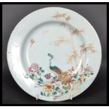 An 18th century Chinese Qing Long Famille Rose plate hand painted with enamels depicting floral