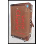 A vintage suitcase of large canvas construction being formerly owned by a magician with notation