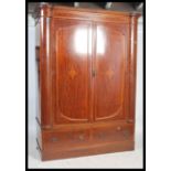 An impressive Edwardian mahogany inlaid large bow fronted double wardrobe armoire. Raised on a
