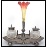 A silver plated desk tidy / ink well having a central glass epergne ruby glass pen holder flanked by