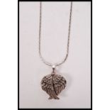 A silver three section locket in the form of the wings of peace complete with silver chain having