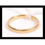 A hallmarked 22ct gold wedding band ring of typical form. Weighs 2.6 grams size K.