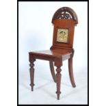 A late 19th century Victorian mahogany hall chair, inset with Minton tile to back rest, the tile