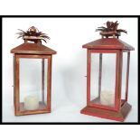A pair of 20th century porch lantern lamps of square form having a painted red colour with four
