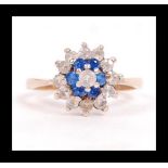 A hallmarked 9ct gold cluster ring set with blue and white stones. Hallmarked Birmingham. Weight 2.