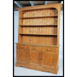 A good quality antique style pine welsh dresser. The base on plinth with a series of cupboards and
