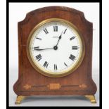 An early 20th century Edwardian mahogany mantel clock having box wood inlay. The white enamel dial