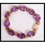 A superb vintage 14ct gold and synthetic alexandrite / colour change sapphire bracelet being set