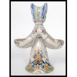 A Continental faience salt modelled as an 18th century double sided  lady with each side holding a