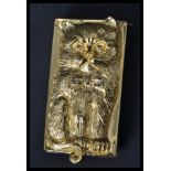 A gilt silver vesta case in the form of a cat with marcasite bow and eyes. Weighs 60.5 grams.