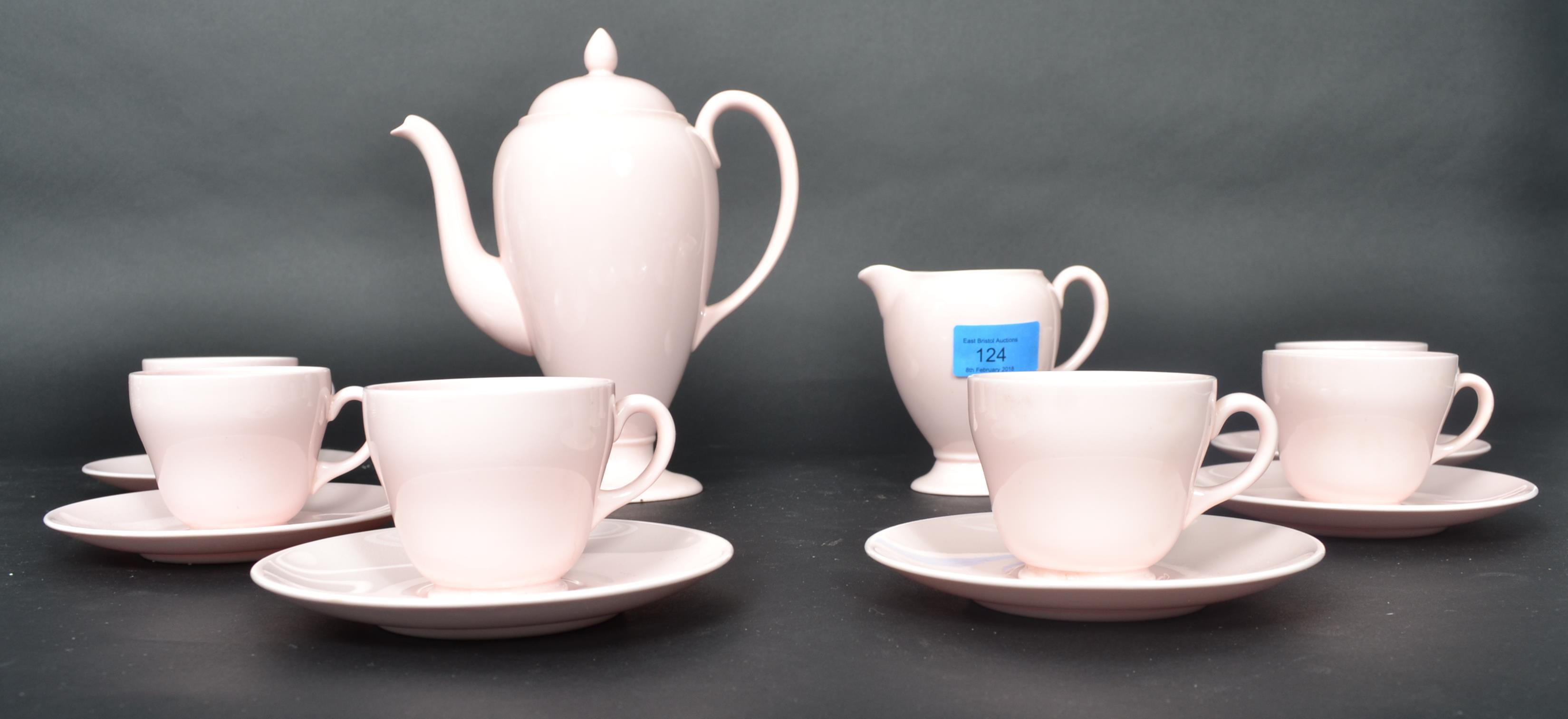 A Wedgwood ceramic tea service in the Alpine Pink pattern consisting of cups saucers tea pot creamer