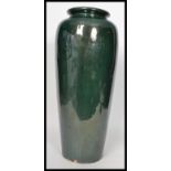 A vintage 20th century large floor standing pottery vase stick umbrella stand having a deep green