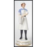 A Michael Sutty ceramic figurine of a nurse limited edition 53/250 model number 1986. Measures 20.